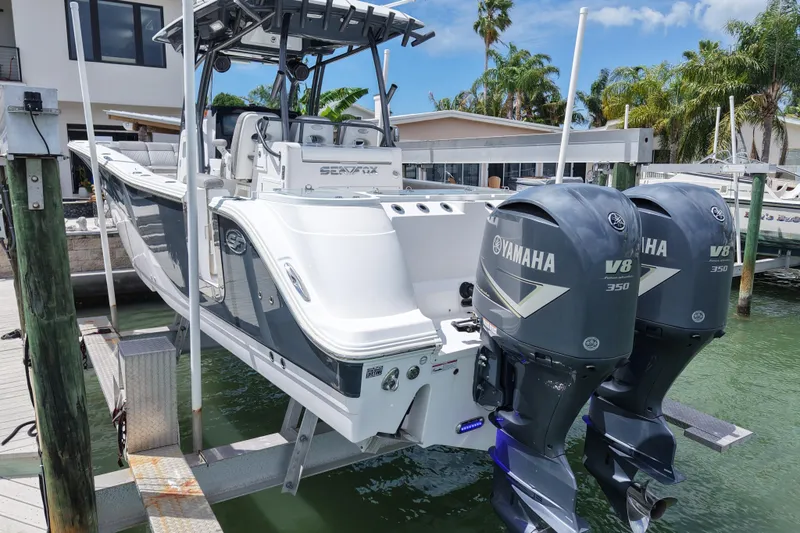 Slide: The Image of 2019 Sea Fox 328 Commander boat with twin Yamaha V8 350 engines docked by waterfront homes. - 9
