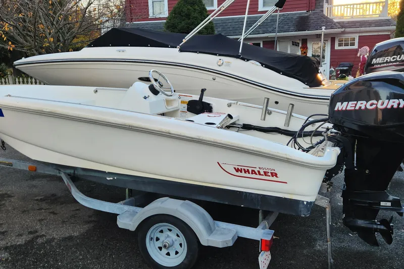 The Image of 2011 Boston Whaler 130 Super Sport boat on trailer with Mercury outboard motor. - 0