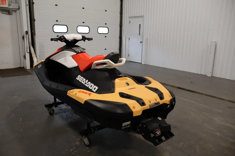 Slide: The Image of 2025 Sea-Doo Spark 2up jet ski in a garage, showcasing vibrant design and compact build. - 7