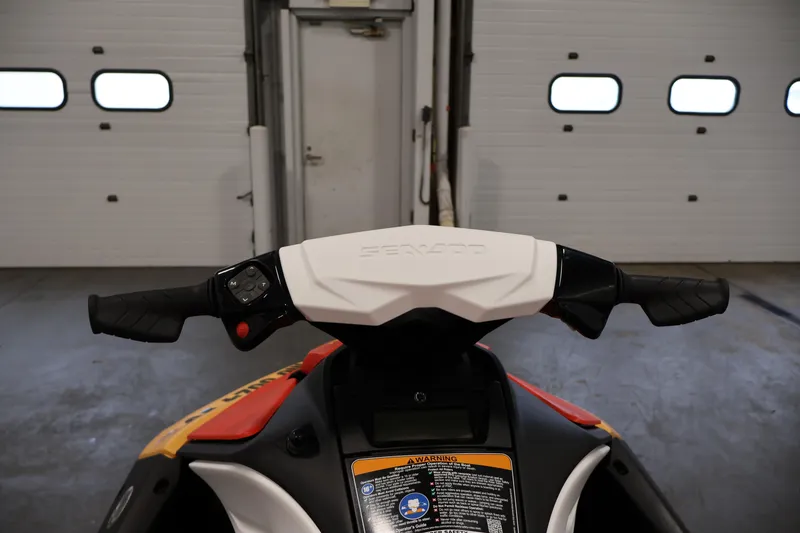 Slide: The Image of 2025 Sea-Doo Spark 2up handlebars in a garage setting. - 9