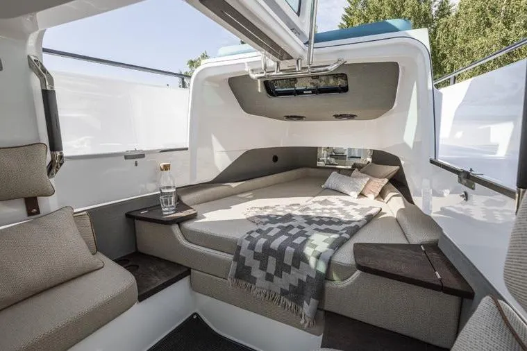Slide: The Image of Luxurious interior of 2027 Axopar 37 XC Cross Cabin with cozy bedding and modern design. - 4