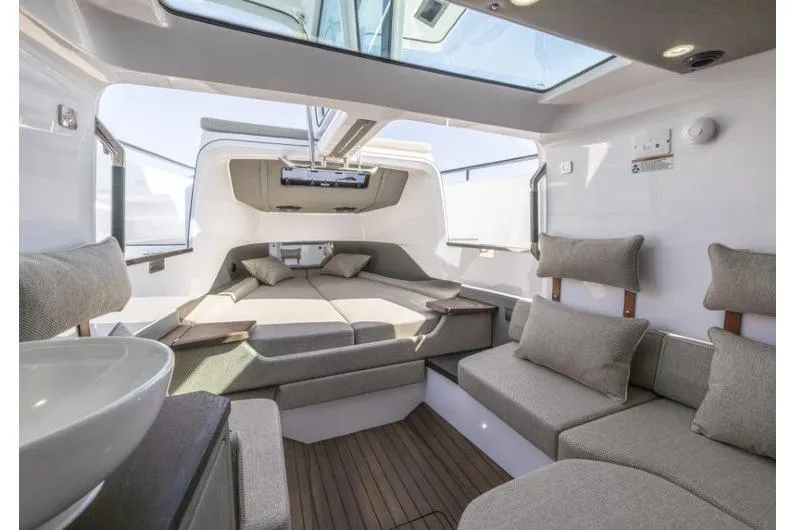 Slide: The Image of Luxurious interior of 2027 Axopar 37 XC Cross Cabin with modern seating and skylight. - 5