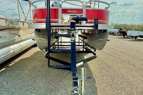 Slide: The Image of 2014 Sun Tracker Bass Buggy 18 DLX pontoon boat on trailer, parked outdoors. - 3