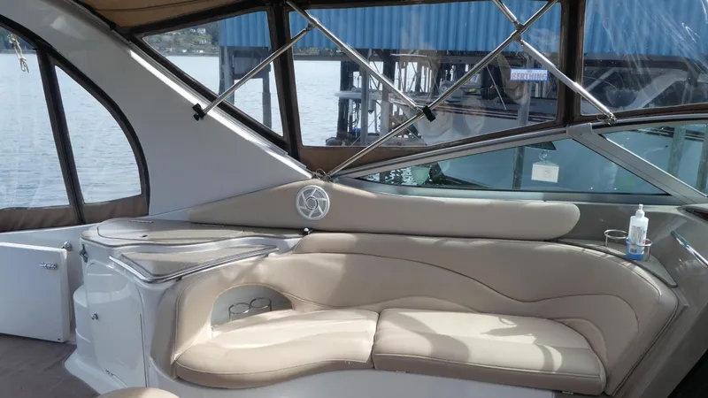 Slide: The Image of Interior of 2004 Larson 370 boat with beige seating and water view. - 10