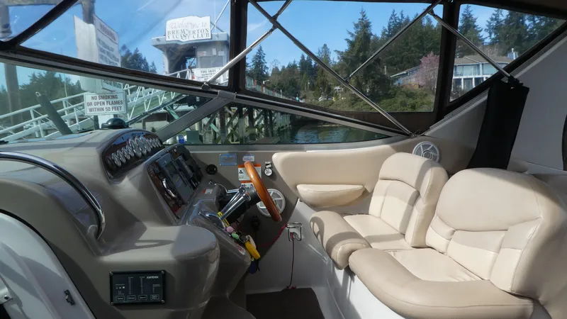Slide: The Image of Interior of a 2004 Larson 370 boat with beige seating and control panel. - 11