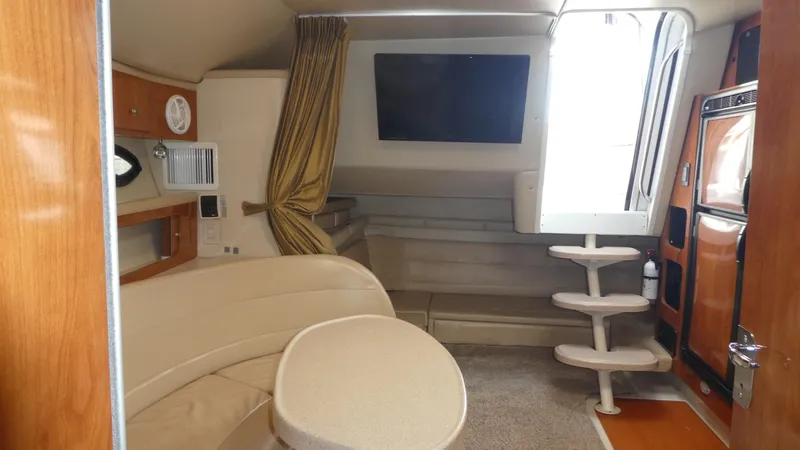 Slide: The Image of Interior of 2004 Larson 370 boat with seating, table, and stairs. - 18