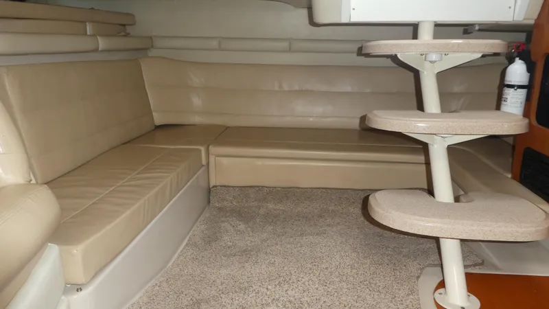 Slide: The Image of Interior of a 2004 Larson 370 boat with beige seating and carpeted flooring. - 19