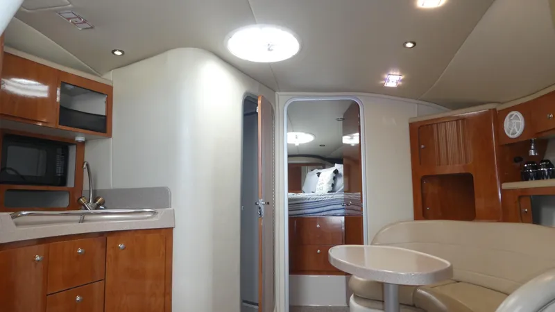 Slide: The Image of Interior of 2004 Larson 370 yacht with kitchen, seating, and sleeping area. - 22