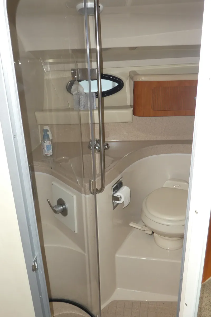 Slide: The Image of 2004 Larson 370 boat bathroom with shower, toilet, and storage cabinet. - 25