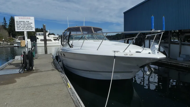 Slide: The Image of 2004 Larson 370 boat docked at marina under clear sky. - 3