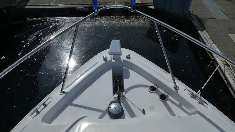 Slide: The Image of Bow view of a 2004 Larson 370 boat docked in a marina. - 33