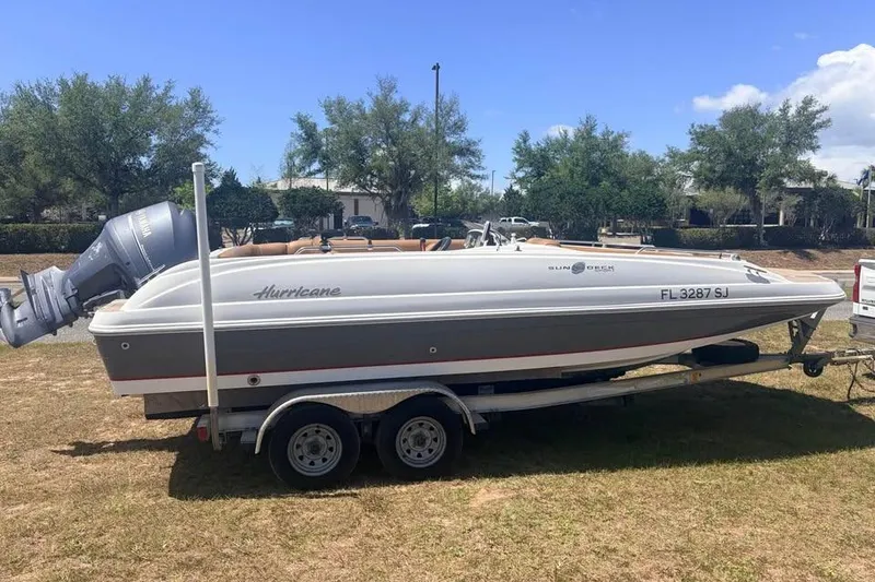 Slide: The Image of 2014 Hurricane SunDeck Sport 201 OB boat on trailer, parked outdoors. - 1