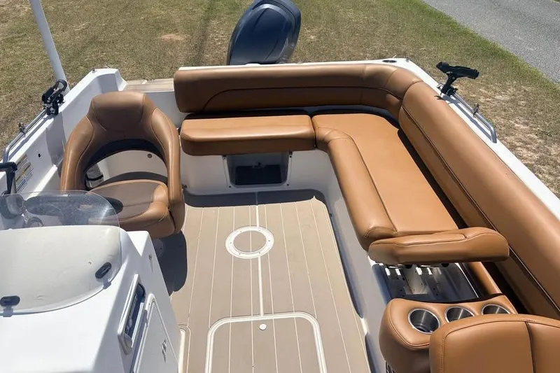 Slide: The Image of 2014 Hurricane SunDeck Sport 201 OB boat interior with tan seating and cup holders. - 11