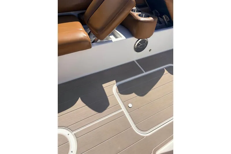 Slide: The Image of 2014 Hurricane SunDeck Sport 201 OB boat interior with brown seating and deck flooring. - 12