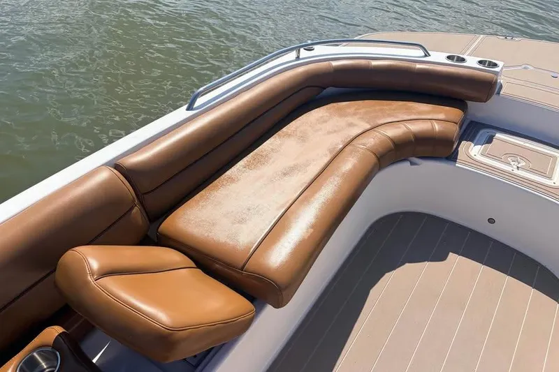 Slide: The Image of 2014 Hurricane SunDeck Sport 201 OB boat with brown leather seating on water. - 3