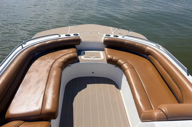 Slide: The Image of 2014 Hurricane SunDeck Sport 201 OB boat with brown seating, on calm water. - 5