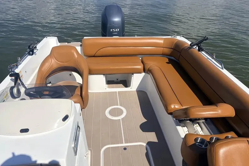 Slide: The Image of 2014 Hurricane SunDeck Sport 201 OB boat interior with tan seating and steering console. - 6
