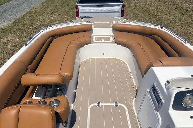 Slide: The Image of 2014 Hurricane SunDeck Sport 201 OB boat with tan seating and cup holders. - 9
