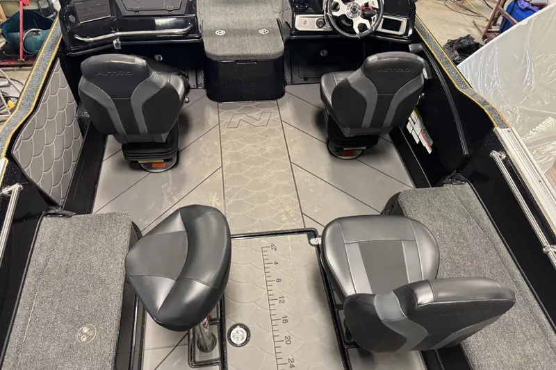 Slide: The Image of Interior of a 2026 Nitro ZV21 boat with four black seats and a steering console. - 10