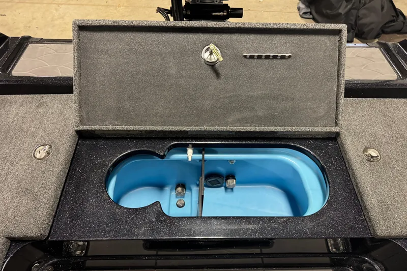 Slide: The Image of 2026 Nitro ZV21 boat storage compartment with open lid and blue interior. - 12