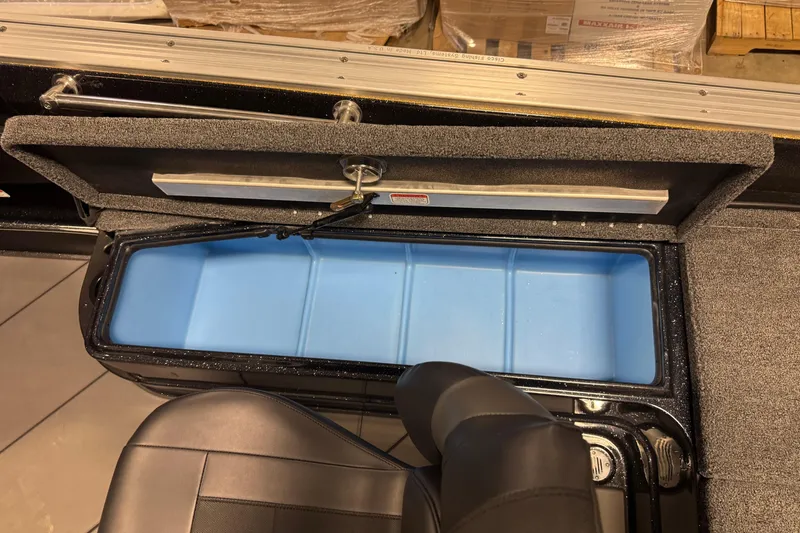 Slide: The Image of Open storage compartment in 2026 Nitro ZV21 boat with blue interior lining. - 13