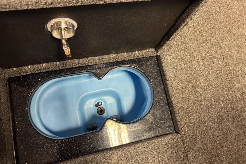 Slide: The Image of Livewell compartment in 2026 Nitro ZV21 boat, featuring a blue interior and secure latch. - 18