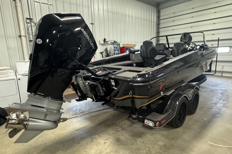 Slide: The Image of 2026 Nitro ZV21 boat with Mercury engine in a garage setting. - 3