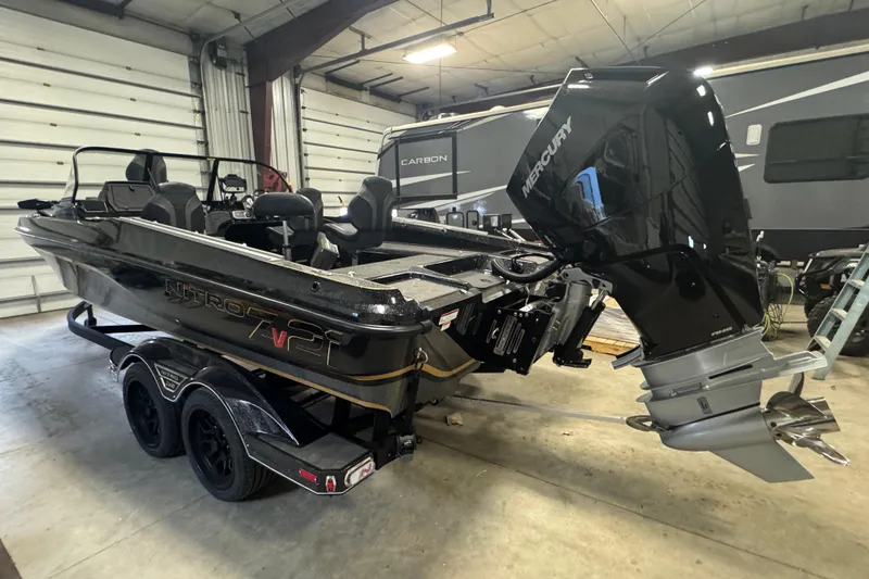 Slide: The Image of 2026 Nitro ZV21 boat with Mercury engine in a garage setting. - 4