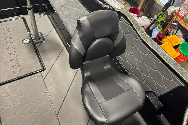 Slide: The Image of Black seat on 2026 Nitro ZV21 boat with textured flooring and measuring ruler. - 8