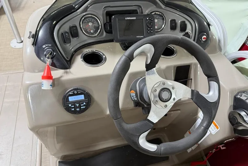 Slide: The Image of Steering console of 2022 SUNTRACKER 22 DLX with gauges and navigation system. - 14