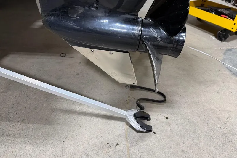 Slide: The Image of Close-up of a 2022 SUNTRACKER 22 DLX boat propeller and motor on concrete floor. - 4