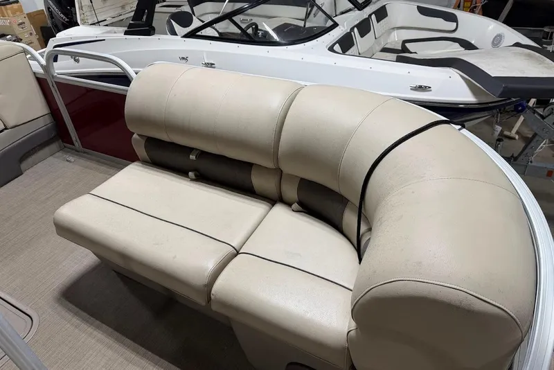 Slide: The Image of Beige seating on 2022 SUNTRACKER 22 DLX pontoon boat, with another boat in background. - 6