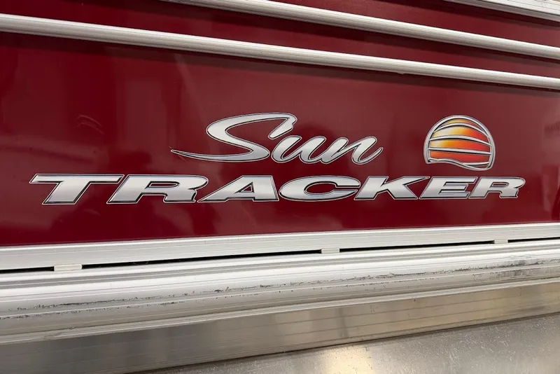 Slide: The Image of Sun Tracker 22 DLX 2022 logo on red background with silver accents. - 7