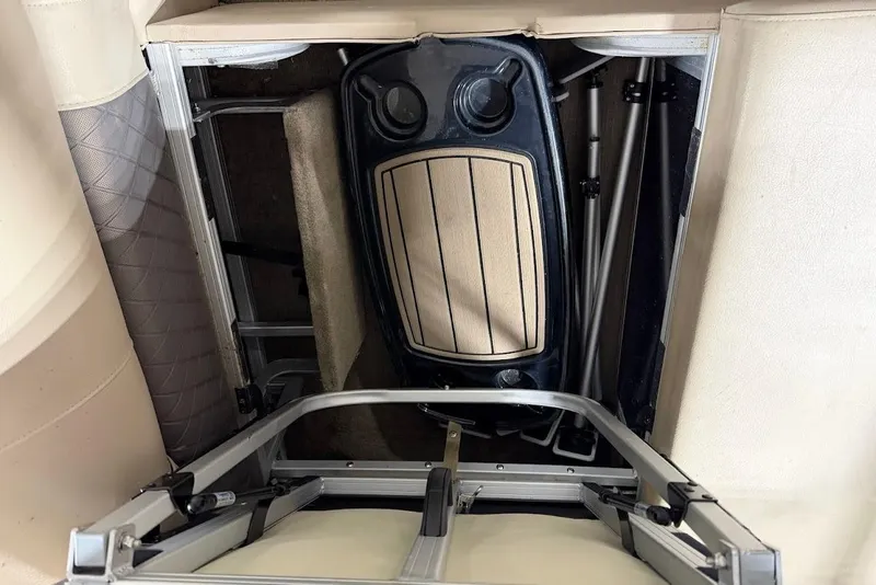 Slide: The Image of Interior storage compartment of 2022 SUNTRACKER 22 DLX boat, showcasing seating and frame. - 8