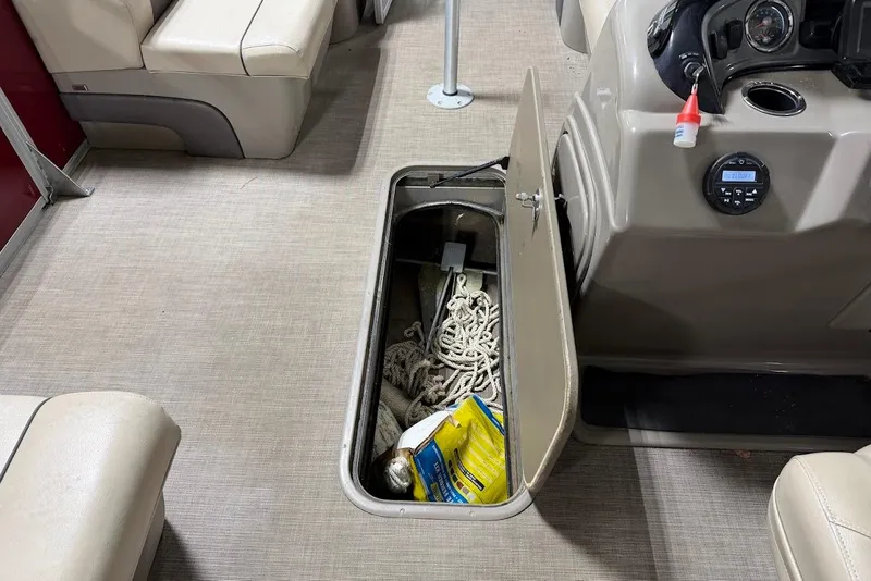 Slide: The Image of Storage compartment on a 2022 SUNTRACKER 22 DLX boat with ropes and supplies. - 9