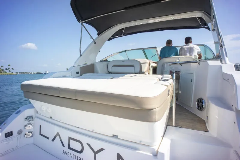 Slide: The Image of 2016 Regal 32 Express yacht with sunbed, cruising on calm waters. - 12