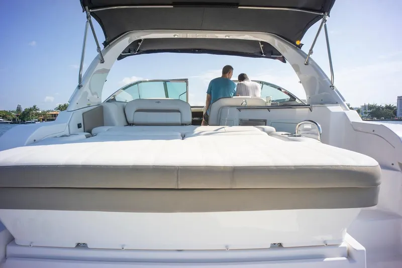 Slide: The Image of 2016 Regal 32 Express yacht with spacious deck and seating, cruising on a sunny day. - 14