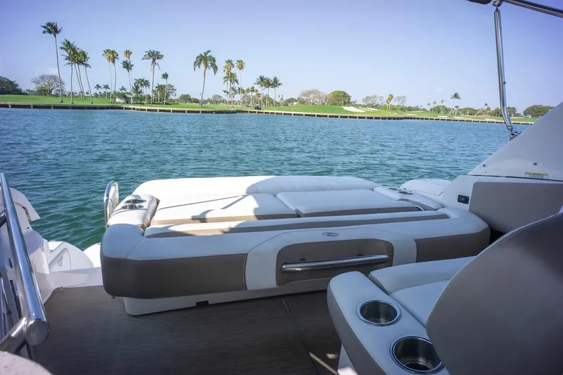 Slide: The Image of 2016 Regal 32 Express boat interior with scenic water and palm trees in the background. - 17