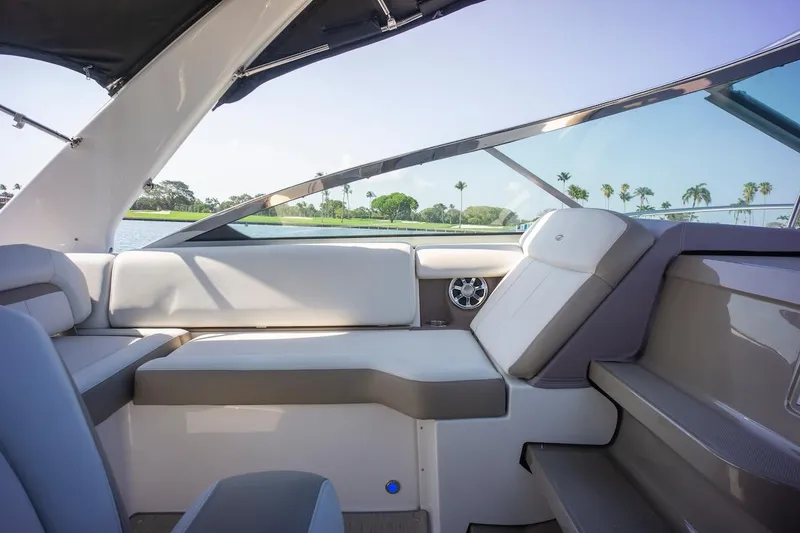 Slide: The Image of Interior of 2016 Regal 32 Express boat with luxurious seating and scenic water view. - 19
