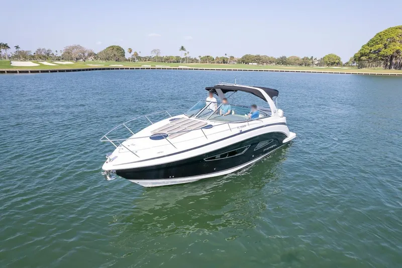 Slide: The Image of 2016 Regal 32 Express boat cruising on a calm lake under clear skies. - 2