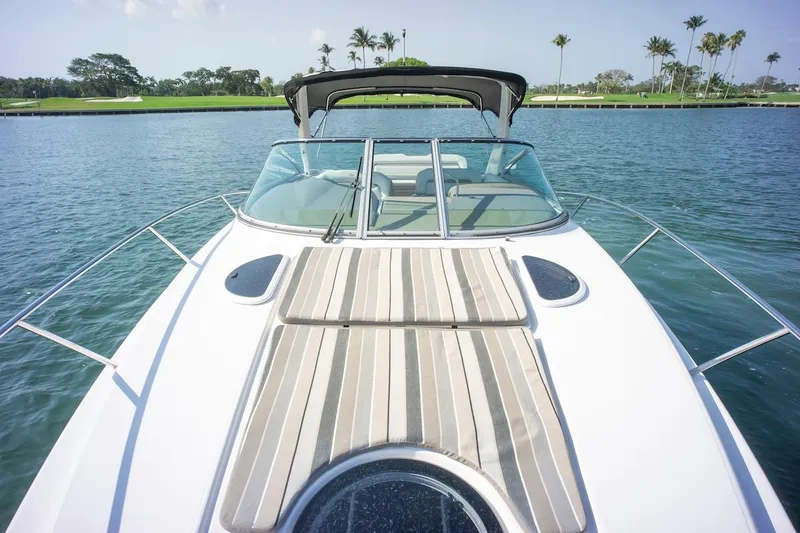 Slide: The Image of 2016 Regal 32 Express boat on water, featuring sunpad and sleek design. - 25