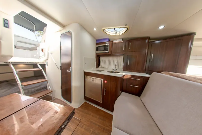 Slide: The Image of Interior of 2016 Regal 32 Express yacht with kitchenette and seating area. - 27