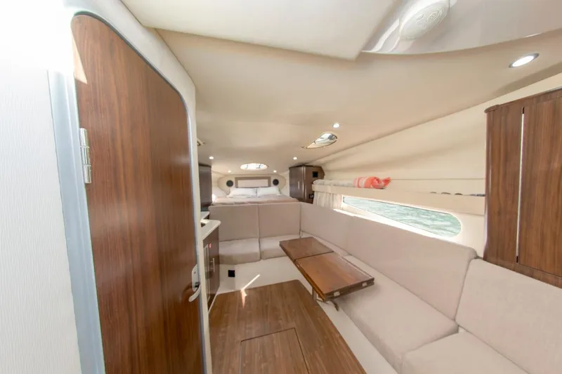 Slide: The Image of Interior of 2016 Regal 32 Express yacht with cozy seating and wooden accents. - 29