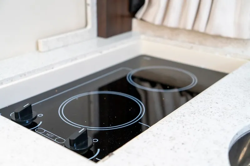 Slide: The Image of Built-in stovetop on 2016 Regal 32 Express yacht kitchen counter. - 33