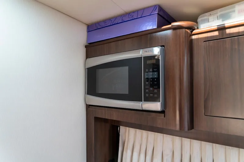 Slide: The Image of Microwave in 2016 Regal 32 Express yacht interior, wooden cabinetry. - 35