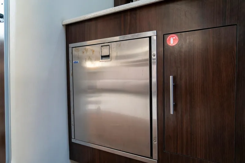 Slide: The Image of Stainless steel appliance on 2016 Regal 32 Express yacht with wooden cabinetry. - 36