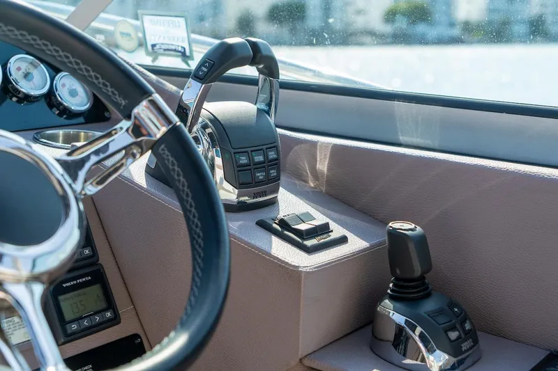 Slide: The Image of Steering and controls of a 2016 Regal 32 Express boat cockpit. - 40