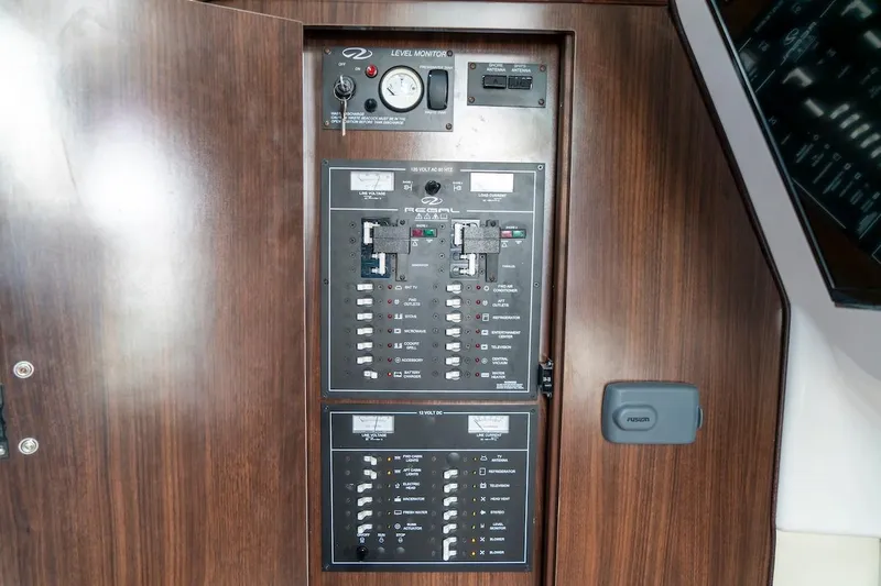 Slide: The Image of Electrical panel of 2016 Regal 32 Express boat with wood finish. - 43