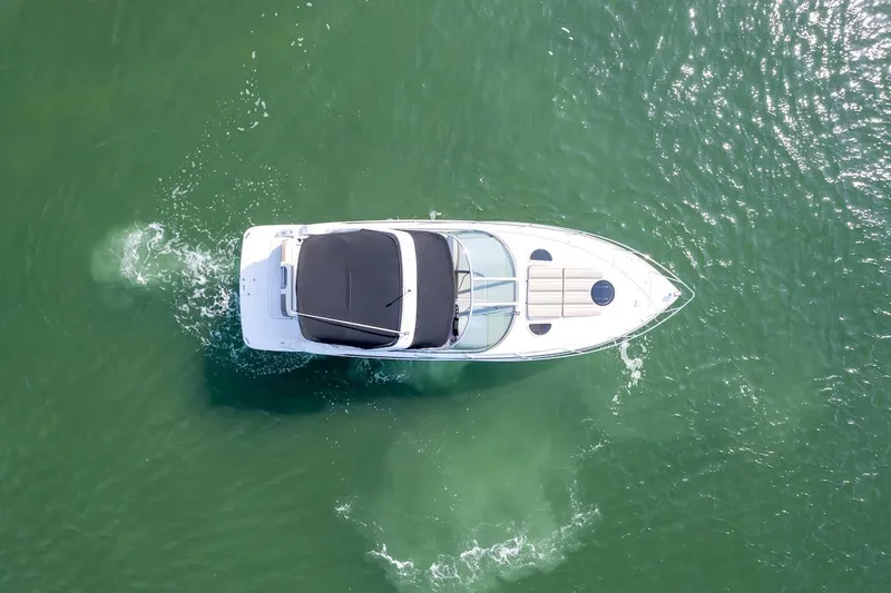 Slide: The Image of Aerial view of 2016 Regal 32 Express boat cruising on green water. - 6