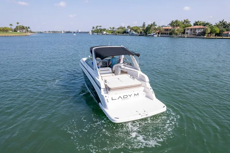 Slide: The Image of 2016 Regal 32 Express boat cruising on a sunny day in a scenic waterway. - 7